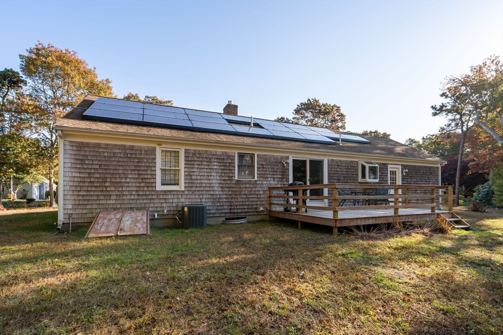 83 Dolar Davis Road Barnstable, MA 02632 - Photo 23 of 36 a backyard of a house with barbeque oven and outdoor seating