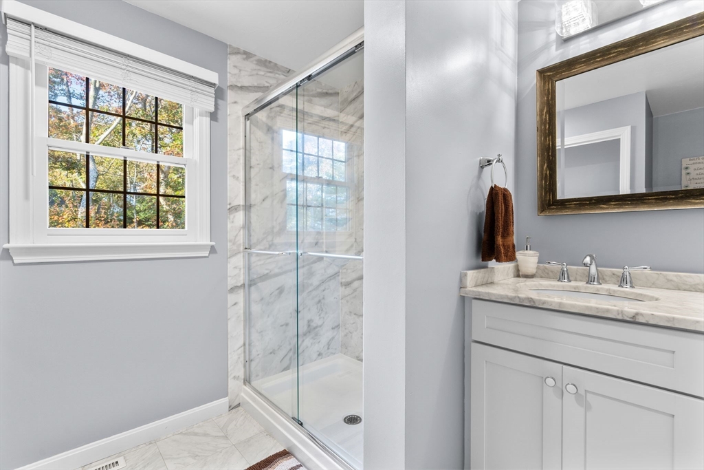 83 Dolar Davis Road Barnstable, MA 02632 - Photo 28 of 36 a bathroom with a granite countertop sink a mirror and a shower