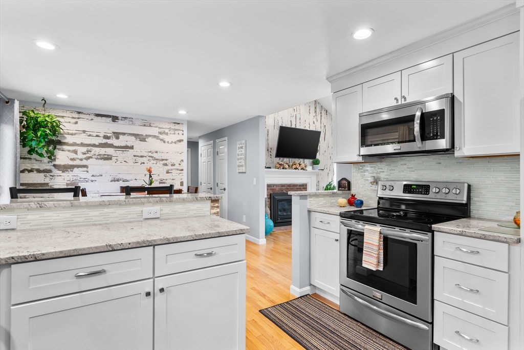 83 Dolar Davis Road Barnstable, MA 02632 - Photo 31 of 36 a kitchen with stainless steel appliances granite countertop a stove and a microwave