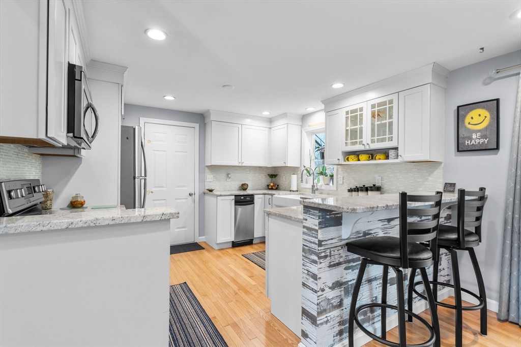 83 Dolar Davis Road Barnstable, MA 02632 - Photo 4 of 36 a kitchen with stainless steel appliances granite countertop a table chairs sink and cabinets