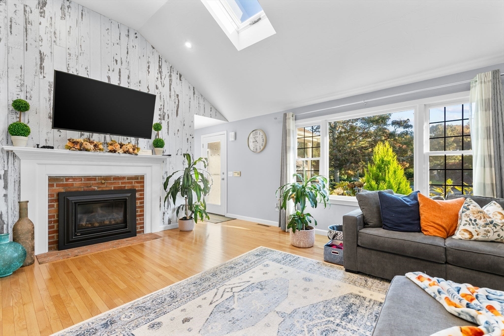 83 Dolar Davis Road Barnstable, MA 02632 - Photo 5 of 36 a living room with furniture a flat screen tv and a fireplace