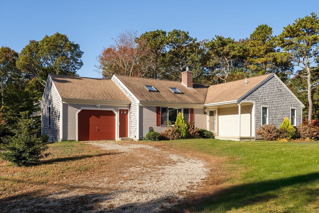83 Dolar Davis Road Barnstable, MA 02632 - Photo 6 of 36 a front view of a house with a yard and garage