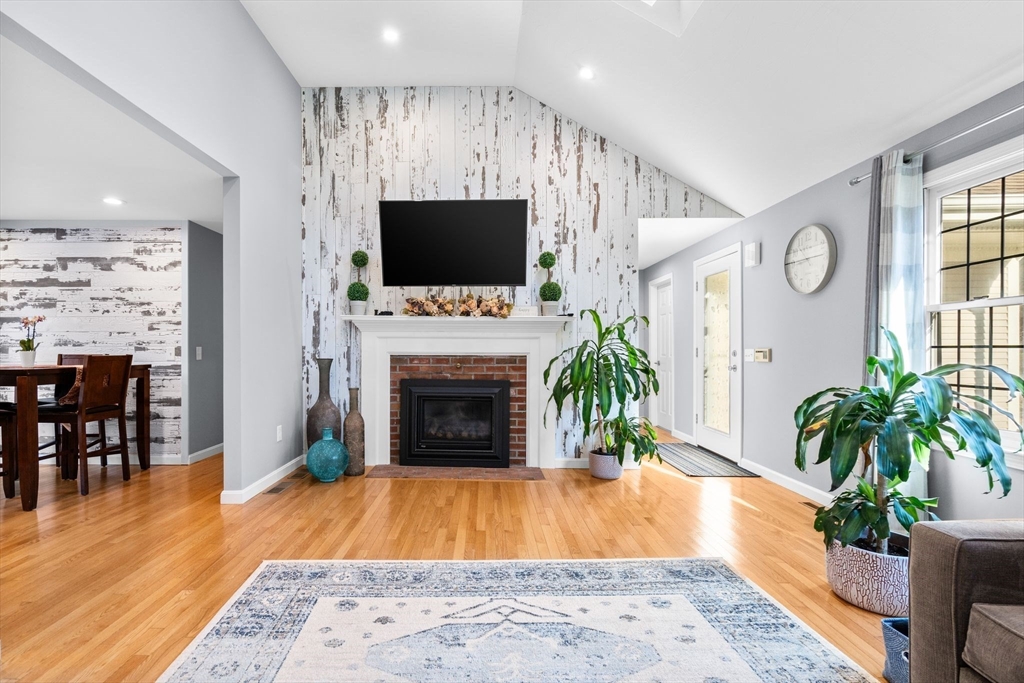 83 Dolar Davis Road Barnstable, MA 02632 - Photo 9 of 36 a living room with furniture a flat screen tv and a fireplace