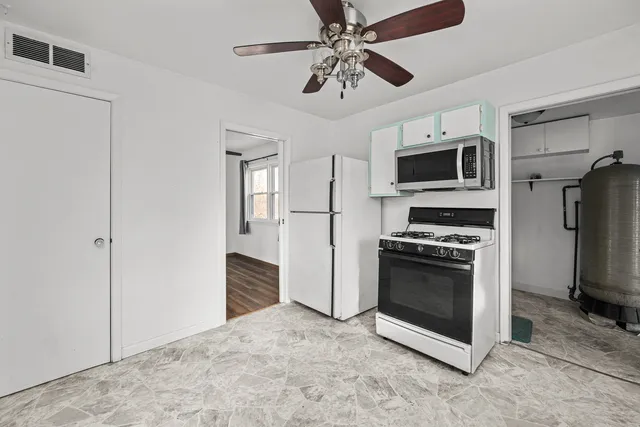 a kitchen with stainless steel appliances a stove microwave and refrigerator