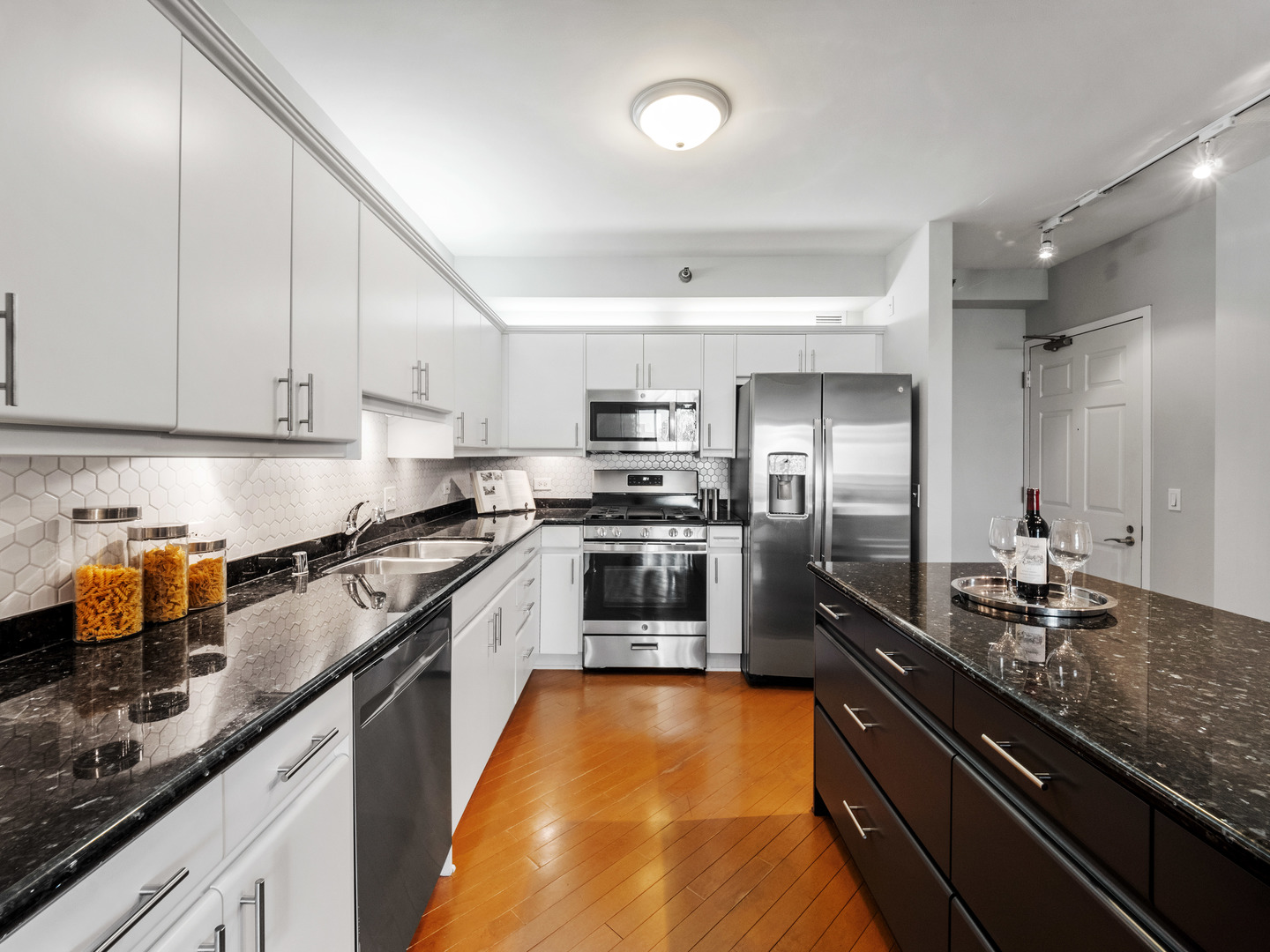 55 West Delaware Place, Unit 921 Chicago, IL 60610 - Photo 11 of 33 a kitchen with stainless steel appliances granite countertop a sink a stove and a refrigerator