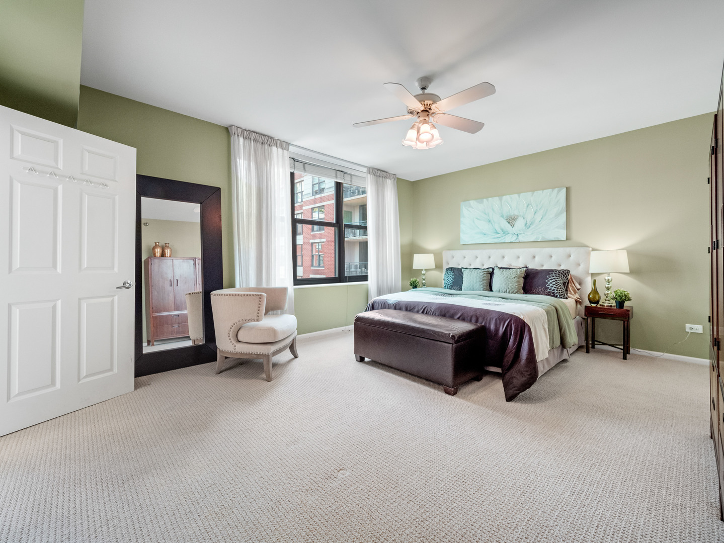 55 West Delaware Place, Unit 921 Chicago, IL 60610 - Photo 13 of 33 a bedroom with a bed and a chandelier