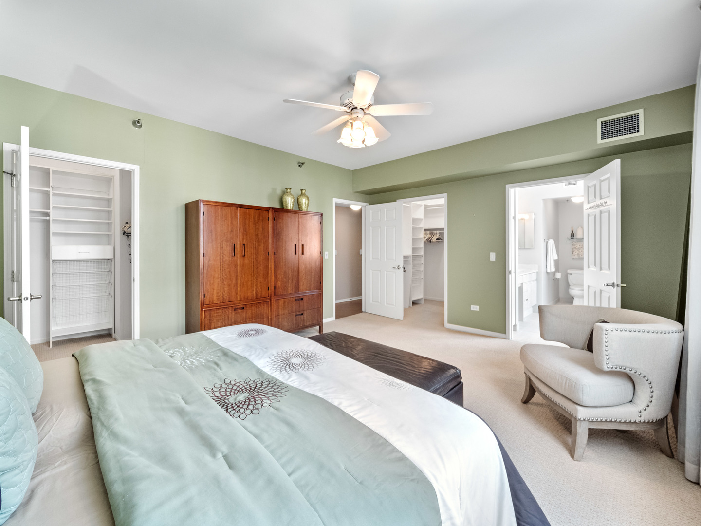 55 West Delaware Place, Unit 921 Chicago, IL 60610 - Photo 15 of 33 a spacious bedroom with a bed and a chandelier