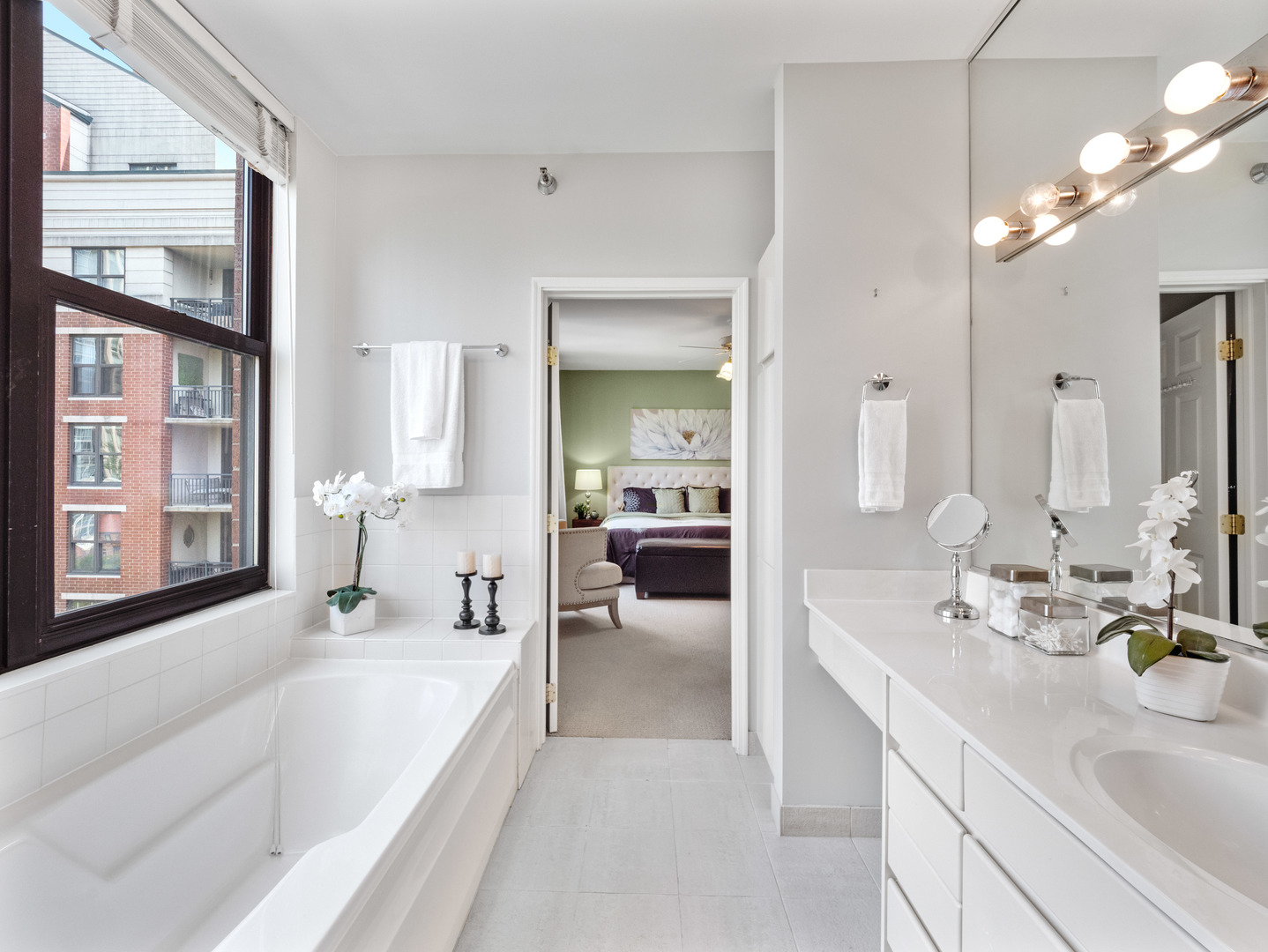 55 West Delaware Place, Unit 921 Chicago, IL 60610 - Photo 17 of 33 a en suite bathroom with a large tub sink and glass door
