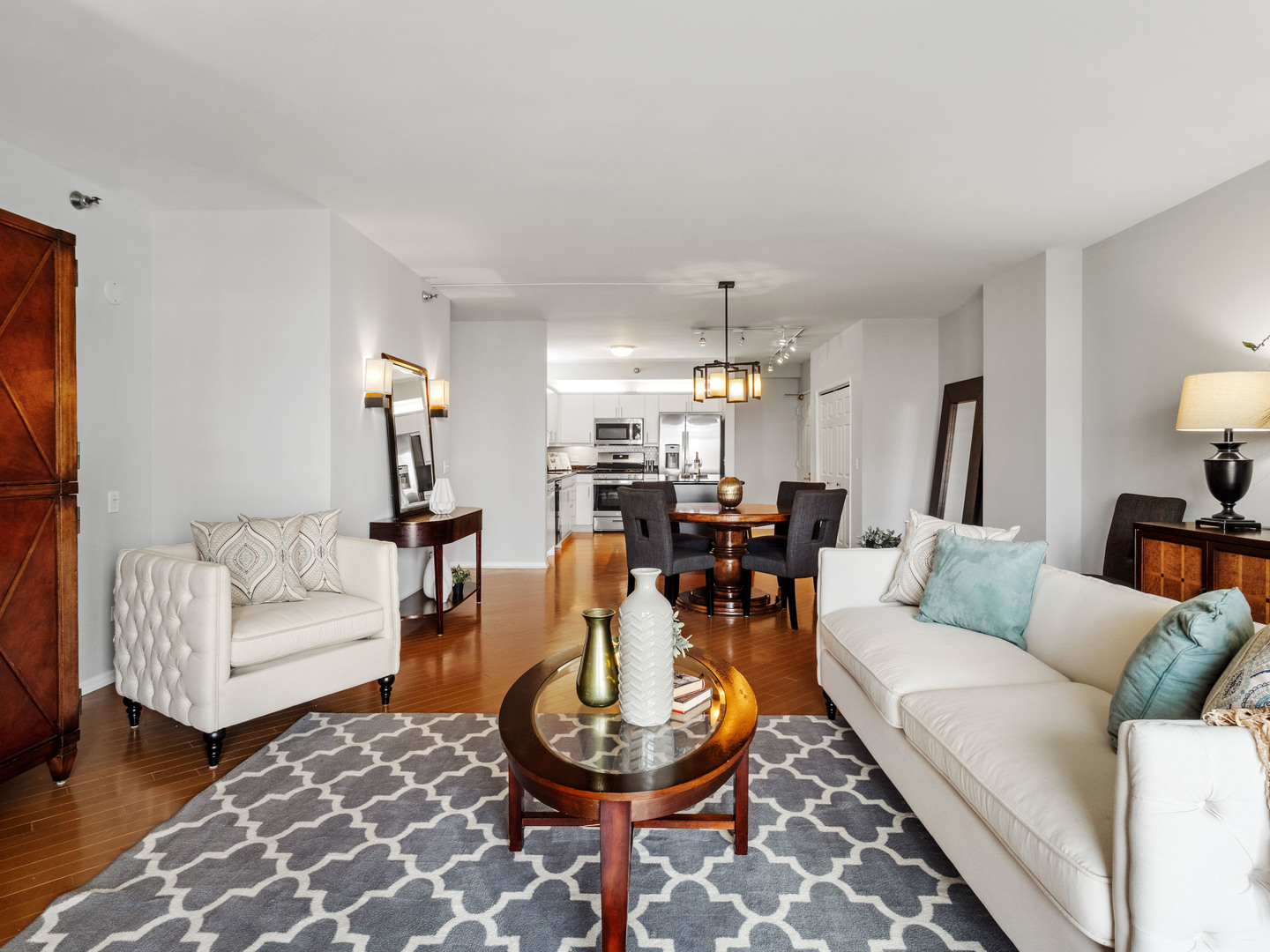 55 West Delaware Place, Unit 921 Chicago, IL 60610 - Photo 7 of 33 a living room with furniture a rug and a chandelier