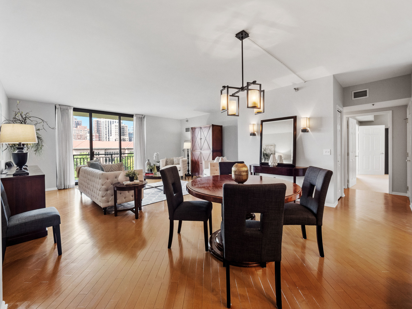 55 West Delaware Place, Unit 921 Chicago, IL 60610 - Photo 8 of 33 a view of a dining room with furniture window and wooden floor