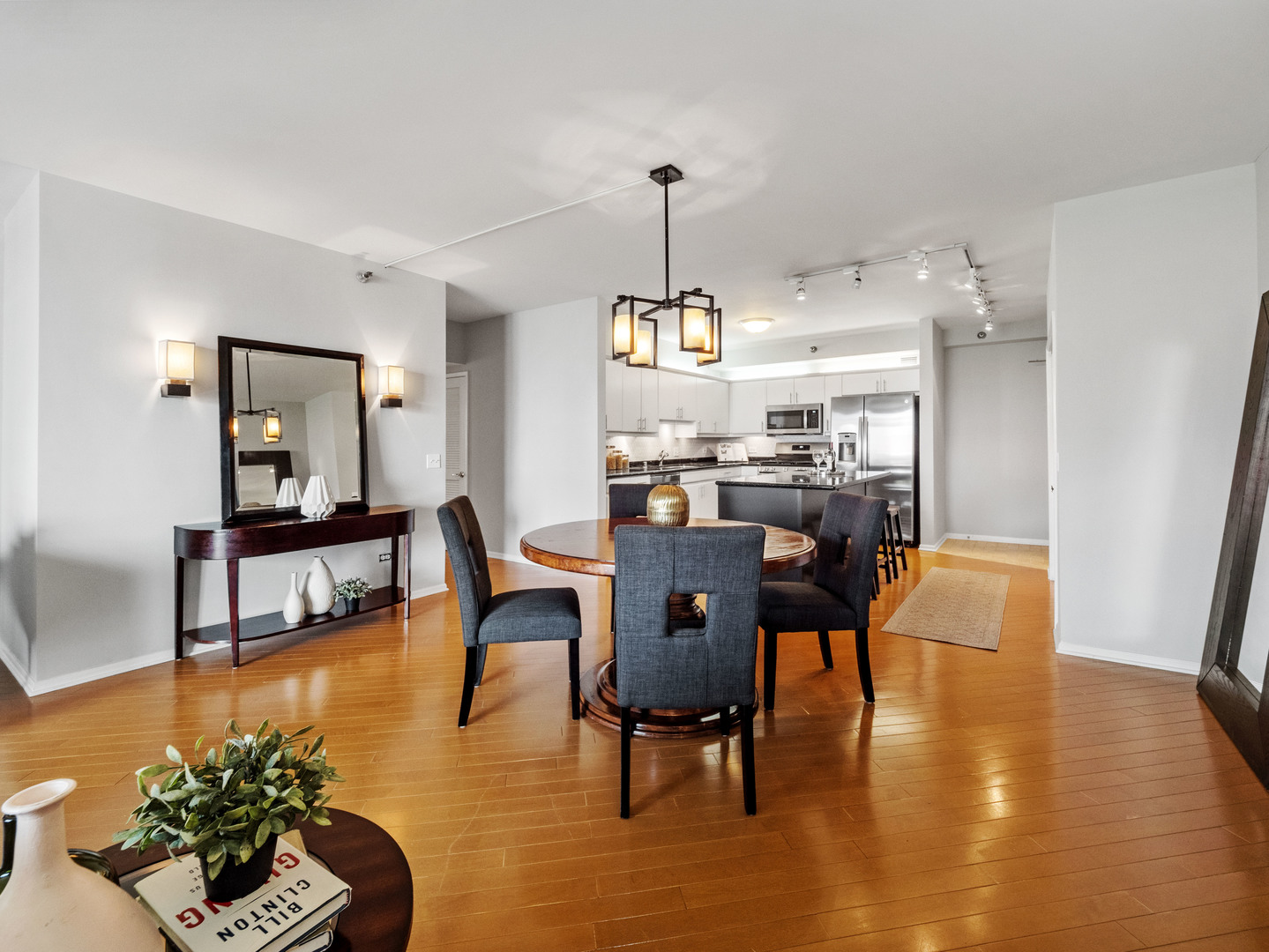 55 West Delaware Place, Unit 921 Chicago, IL 60610 - Photo 9 of 33 a view of a dining room with furniture and a chandelier