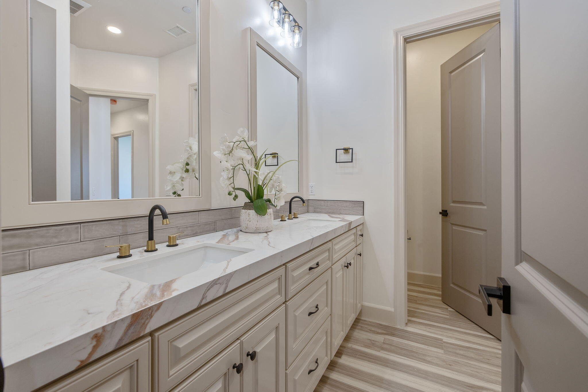 503 East Palm Street Exeter, CA 93221 - Photo 51 of 92 a bathroom with a double vanity sink and a mirror