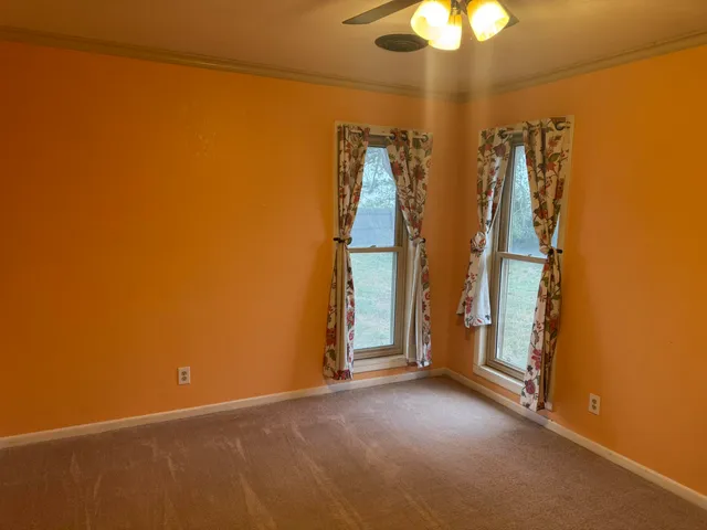 a view of empty room with a fan