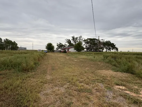 a view of a field with an ocean view