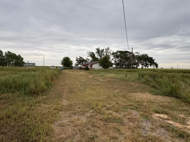 a view of a field with an ocean view
