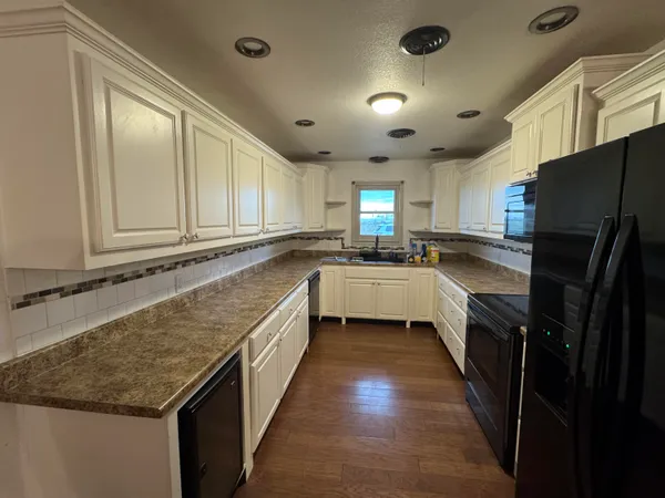 a kitchen with a sink stove and refrigerator
