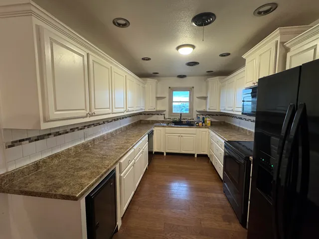 a kitchen with a sink stove and refrigerator