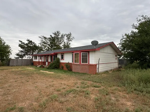 a view of a house with a tree in the background