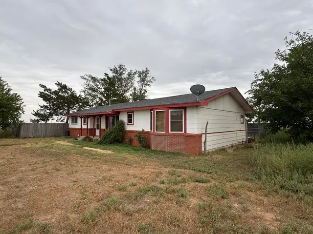 a view of a house with a tree in the background