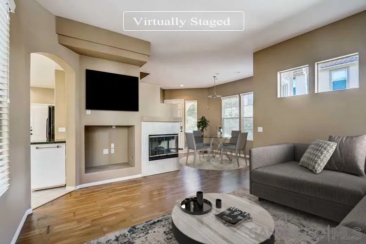 7134 Pintail Drive Carlsbad, CA 92011 - Photo 2 of 30 a living room with furniture a fireplace and a flat screen tv