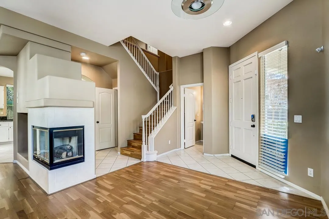 7134 Pintail Drive Carlsbad, CA 92011 - Photo 21 of 30 a view of a livingroom with wooden floor and a fireplace