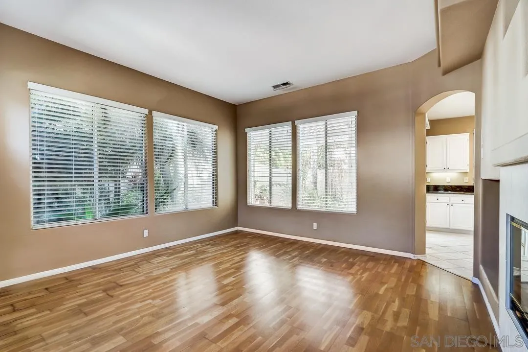 7134 Pintail Drive Carlsbad, CA 92011 - Photo 22 of 30 a view of an empty room with wooden floor and a window