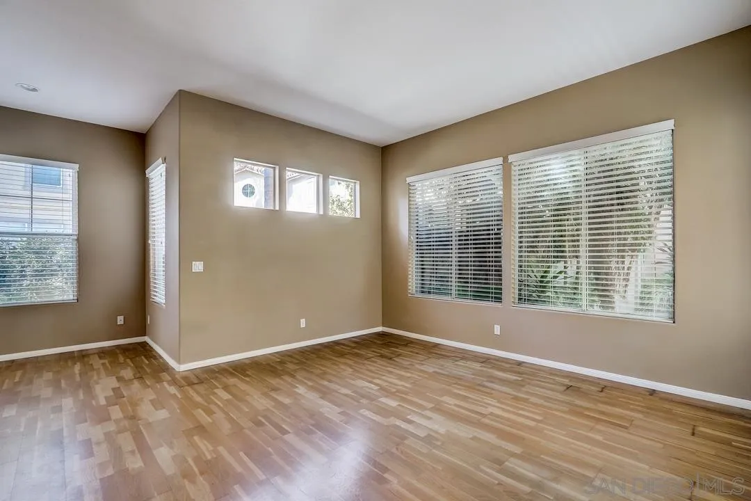 7134 Pintail Drive Carlsbad, CA 92011 - Photo 23 of 30 a view of an empty room with wooden floor and a window