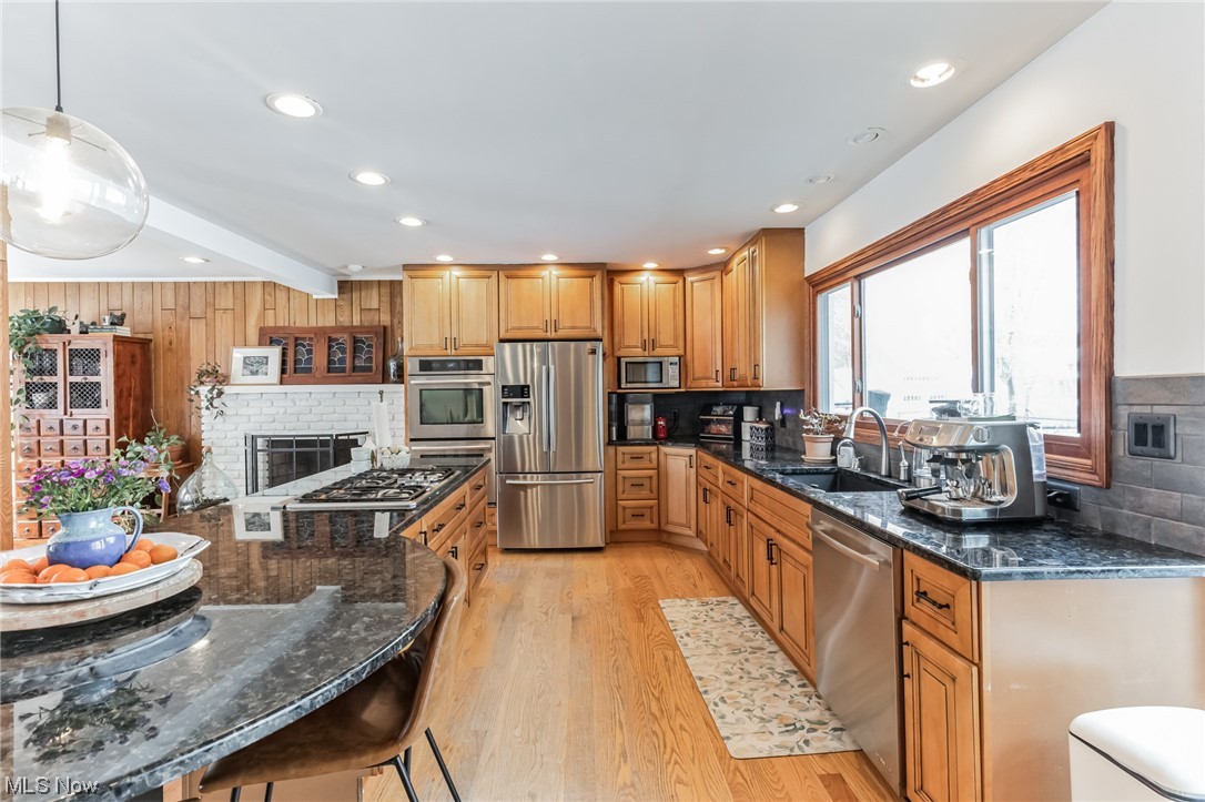 1429 Bell Road Chagrin Falls, OH 44022 - Photo 4 of 42 Kitchen with sink, decorative light fixtures, stainless steel appliances, granite counters