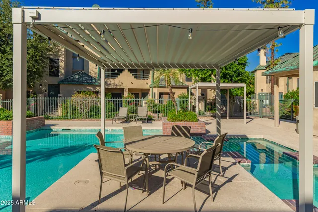 a view of a patio with a table chairs and a backyard