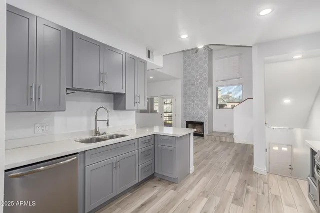 a kitchen with sink cabinets and wooden floor