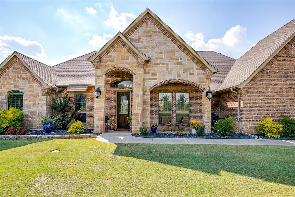 a view of house with yard and outdoor seating