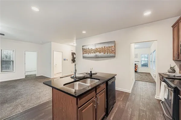a kitchen with kitchen island a sink table and chairs