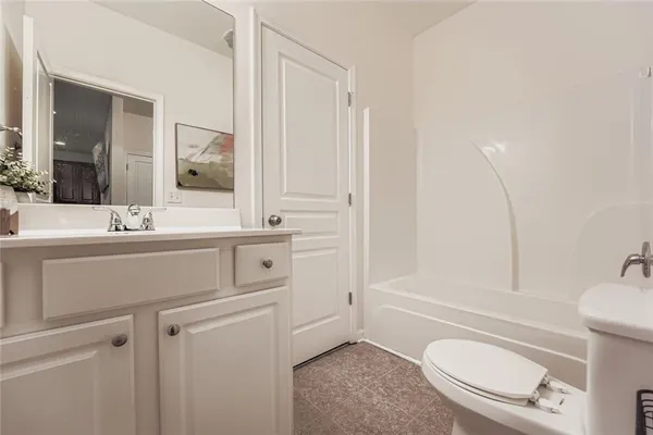 a bathroom with a sink a toilet a mirror and shower