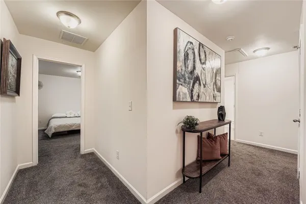 a view of a hallway to a livingroom with furniture and furniture