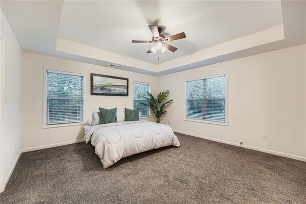 a spacious bedroom with a large bed and a window