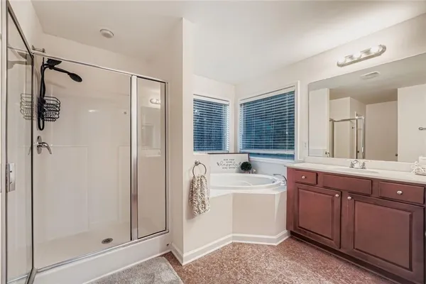 a bathroom with a double vanity sink mirror and shower