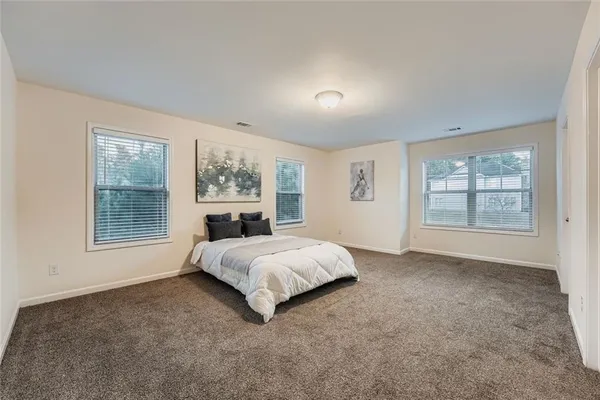 a spacious bedroom with a large bed and a window