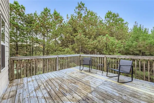 a view of balcony with wooden floor and outdoor seating