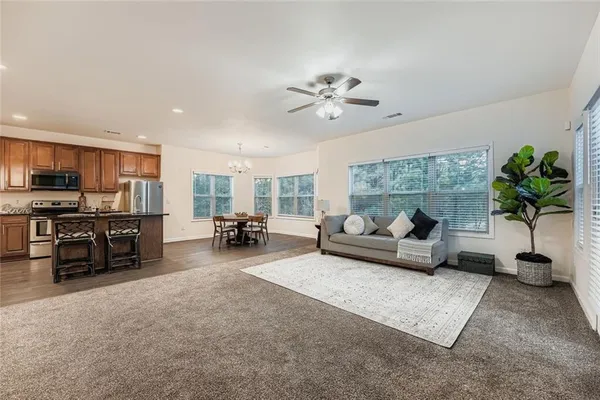 a living room with furniture a patio and a chandelier