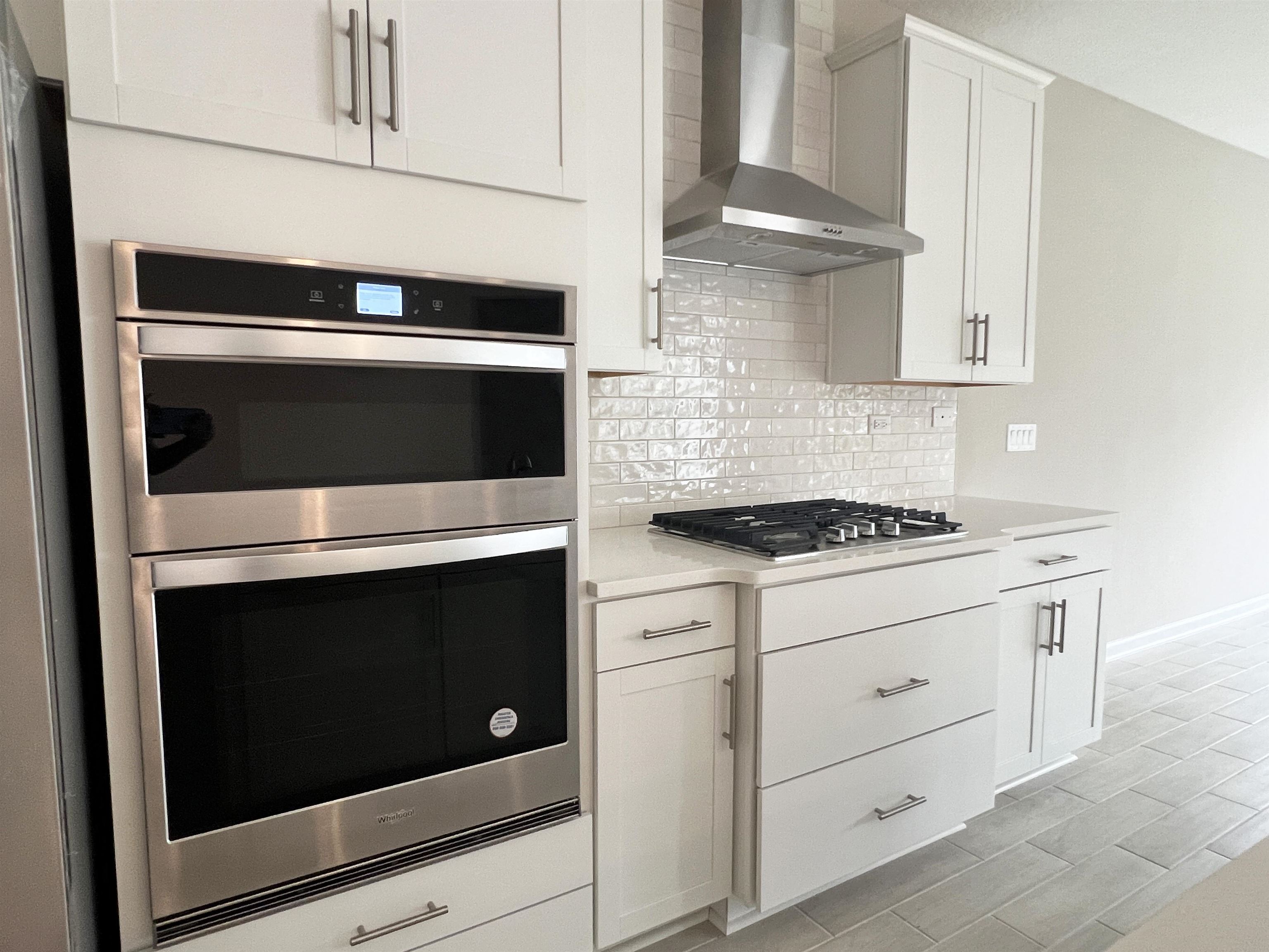 385 Brookgreen Way St. Augustine, FL 32092 - Photo 11 of 31 a kitchen with granite countertop cabinets stainless steel appliances and wooden cabinets