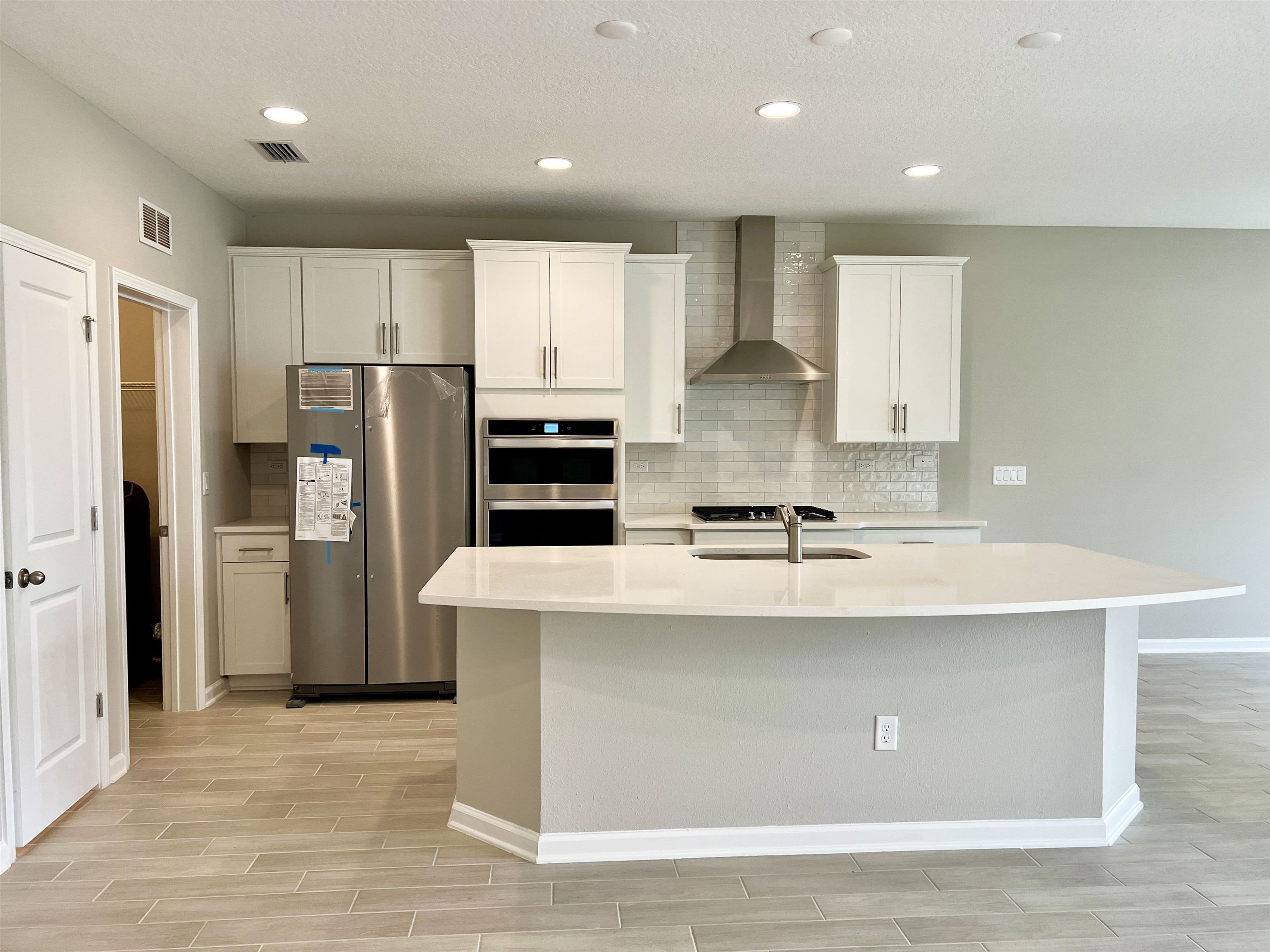 385 Brookgreen Way St. Augustine, FL 32092 - Photo 12 of 31 a kitchen with stainless steel appliances a refrigerator and a sink