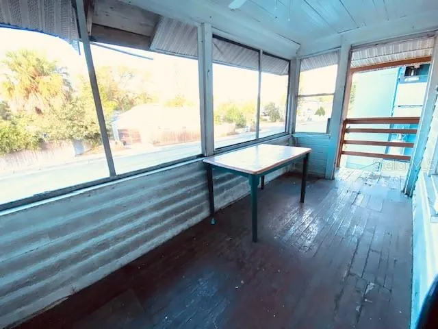 a view of room with wooden floor and a floor to ceiling window