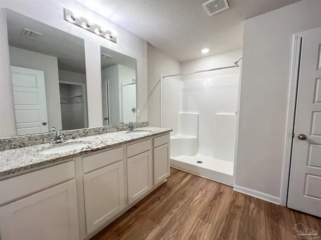 a bathroom with a double vanity sink and mirror