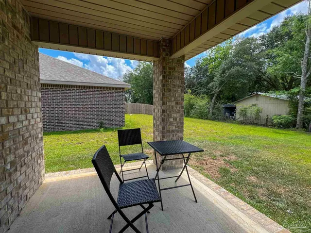 a view of a patio with table and chairs potted plants with sky view