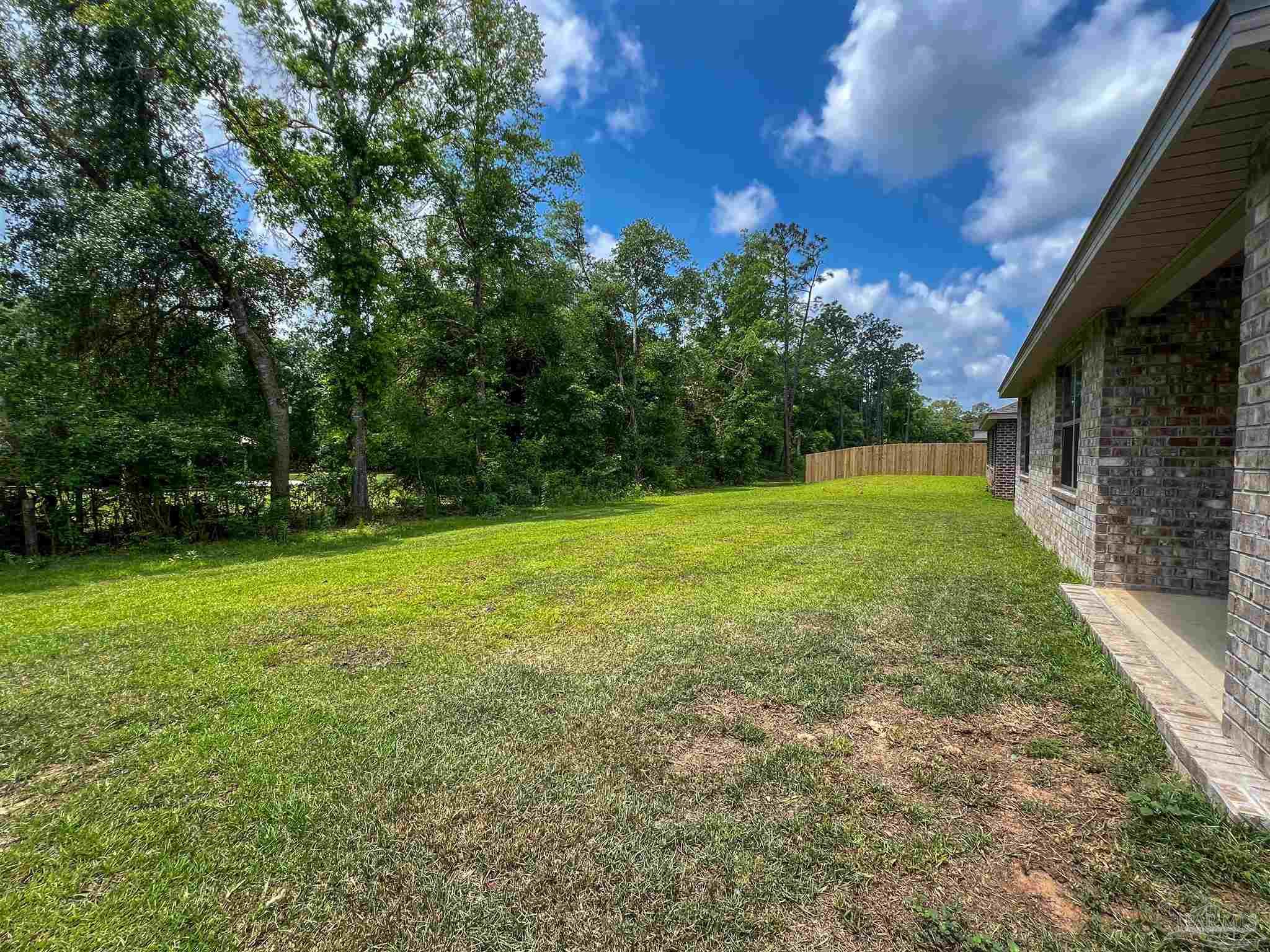 6351 Burrow Lane Pensacola, FL 32526 - Photo 20 of 25 a view of a field with a tree