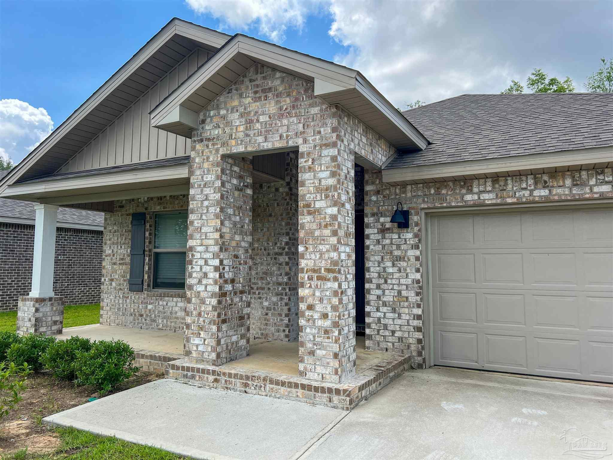 6351 Burrow Lane Pensacola, FL 32526 - Photo 2 of 25 a front view of a house with a garden