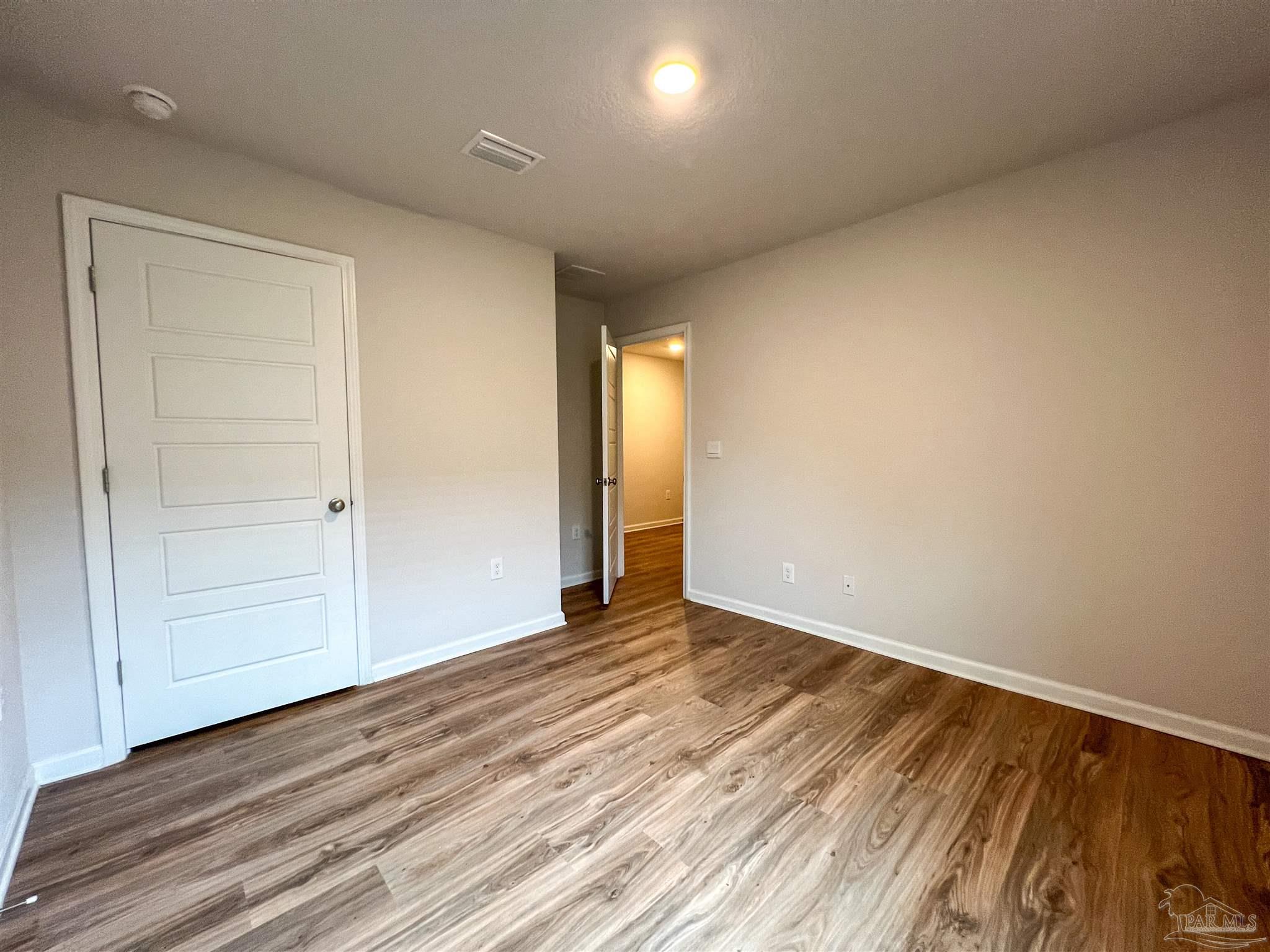 6351 Burrow Lane Pensacola, FL 32526 - Photo 25 of 25 a view of an empty room with wooden floor