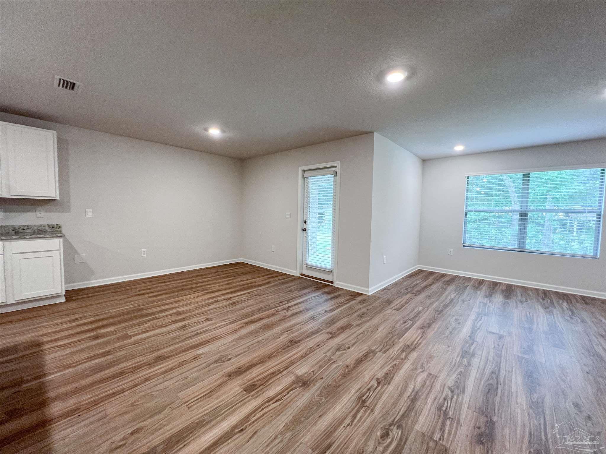 6351 Burrow Lane Pensacola, FL 32526 - Photo 7 of 25 a view of empty room with wooden floor and fan