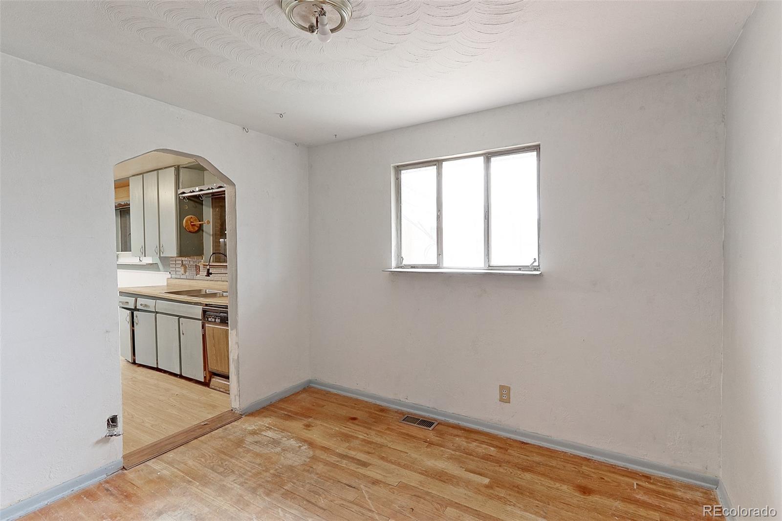 7190 Beach Street Westminster, CO 80030 - Photo 11 of 19 a view of a kitchen with a sink and dishwasher wooden floor