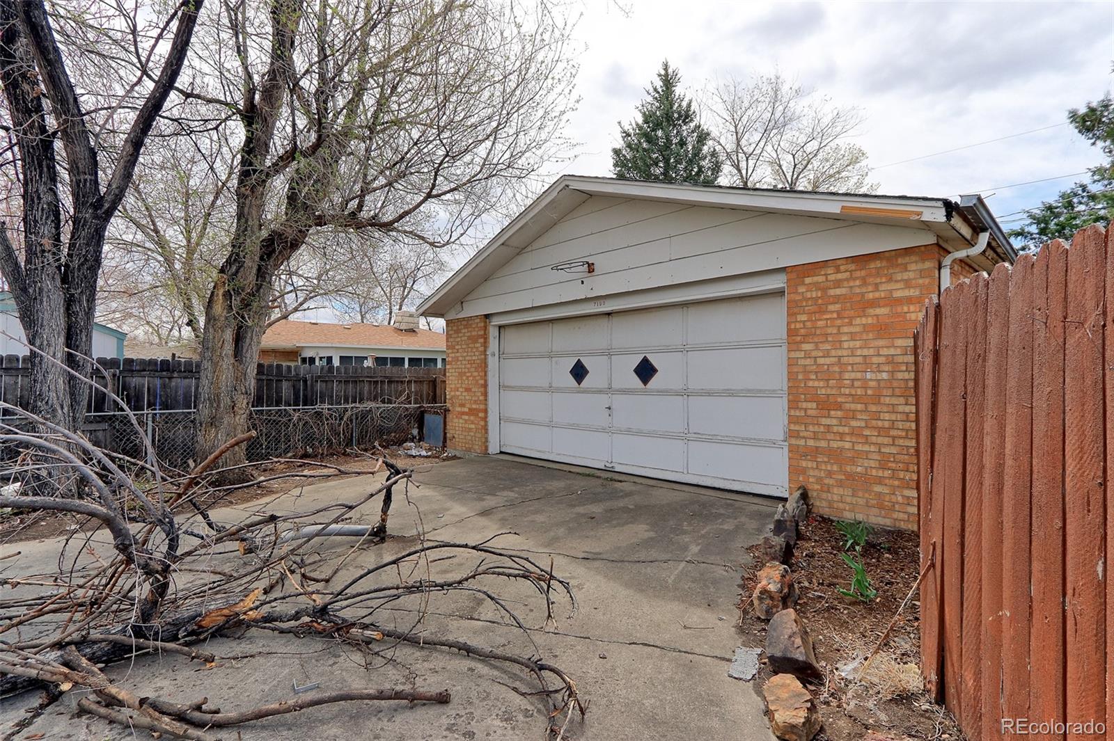 7190 Beach Street Westminster, CO 80030 - Photo 18 of 19 a front view of a house with a yard and garage
